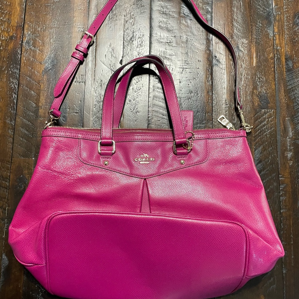 Beautiful hot pink Coach handbag with a removable shoulder strap.